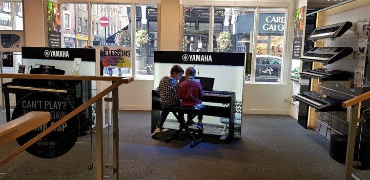 Boys playing keyboard in Yamaha Music London