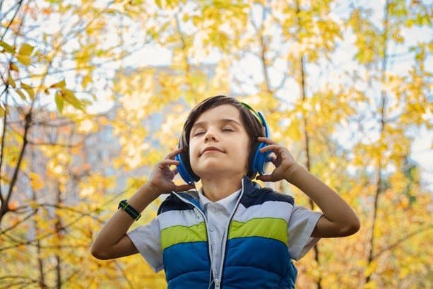 Boy listening headphones to music