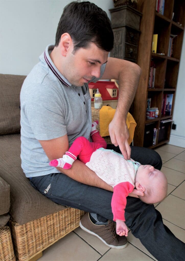 Step 2 - Give up to five chest thrusts
Turn the baby over so they are facing upwards. Place two fingers in the middle of their chest just below the nipples. Push sharply downwards up to five times.