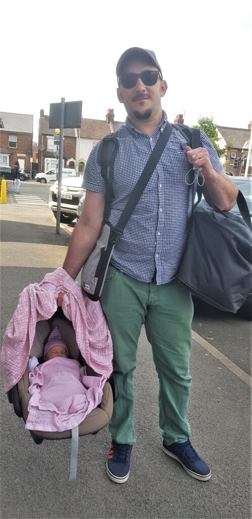 Hubby with Amelia in the car seat for the first ever time